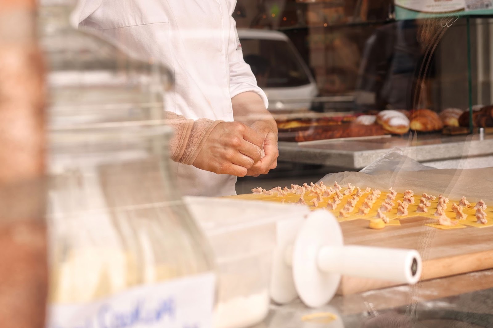 A chef shaping tortellini in Bologna, a city that inspired Dear Emilia | Photo by Austin Carson