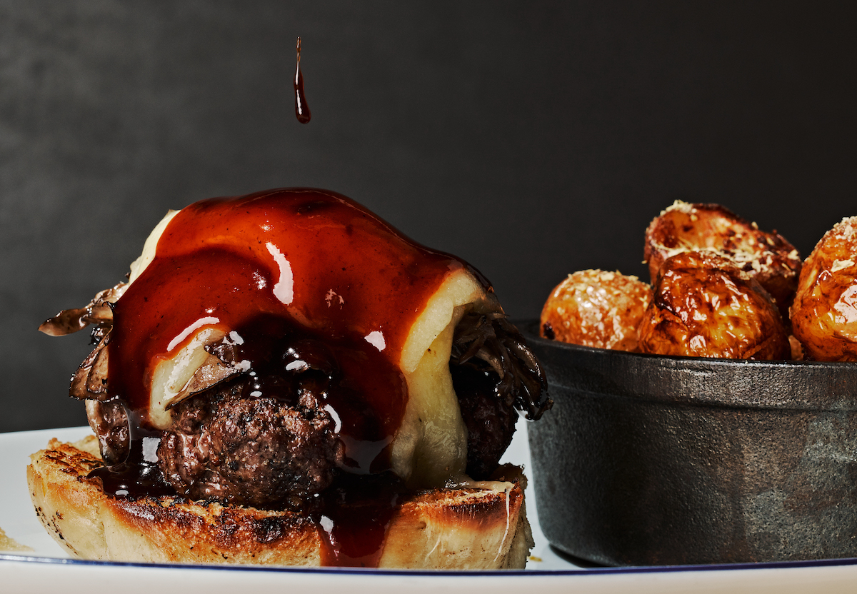 The burger at Deer & Dove gets topped with Bordelais sauce. | Photo by Andrew Thomas Lee