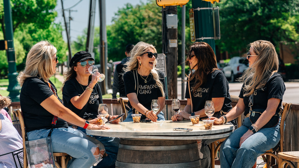 Ladies in matching tees enjoy stops on the Urban Wine Trail. | Photo by Grapevine CVB