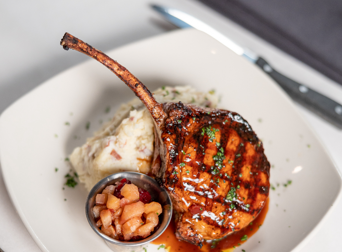 Seared pork chop at Connors Steak & Seafood. | Photo by Connors Steak & Seafood