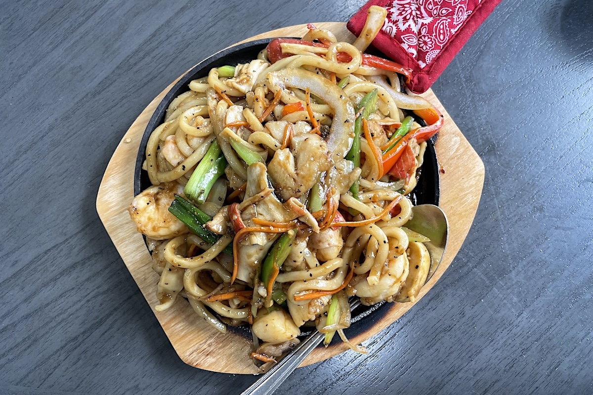 Sizzling stir-fried udon with seafood and black pepper sauce. | Photo by Ruth Tobias