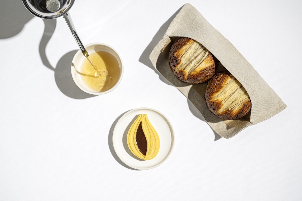 Laminated bread with onion butter and allium broth. | Photo by Evan Sung