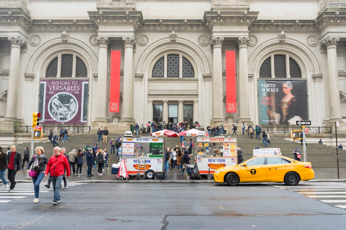 Crowded of tourist walking in front of The Metropolitan Museum on a Rainy Day in New York City