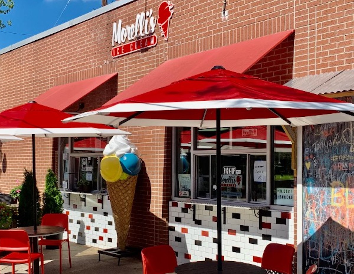 Morelli_s Original Location Photo by Morelli_s Gourmet Ice Cream - DiningOut Bright red umbrellas dot the entrance to Morelli's original location. | Photo by Morelli's Gourmet Ice Cream