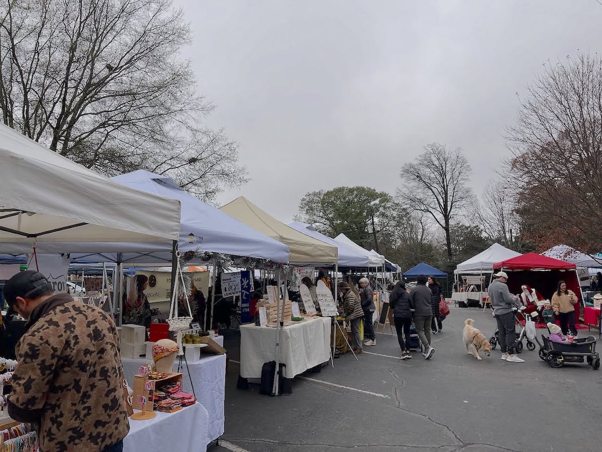 Peach tree - DiningOut Farmers market vendors line up in white and beige tents in a parking lot while shoppers mill about at the Peachtree Road Farmers Market | Photo by Peachtree Road Farmers Market