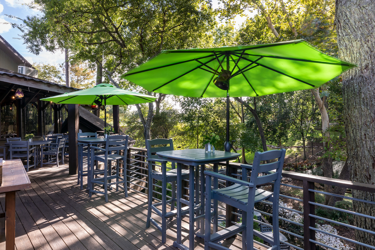 Patio tables on the upper deck at Rainbow Lodge. | Photo by Rainbow Lodge