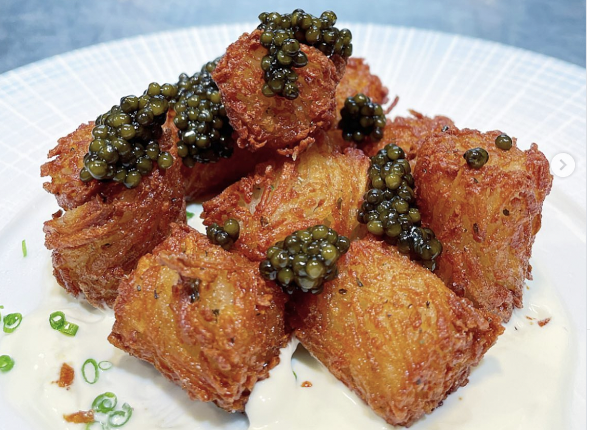 Caviar-topped tater tots garnished with chives at the Chastain. | Photo by the Chastain