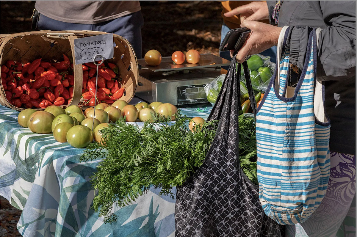 image10 - DiningOut A shopper fills a reusable bag with fresh carrots and peppers at the Green Market at Piedmont Park. | Photo by the Green Market at Piedmont Park