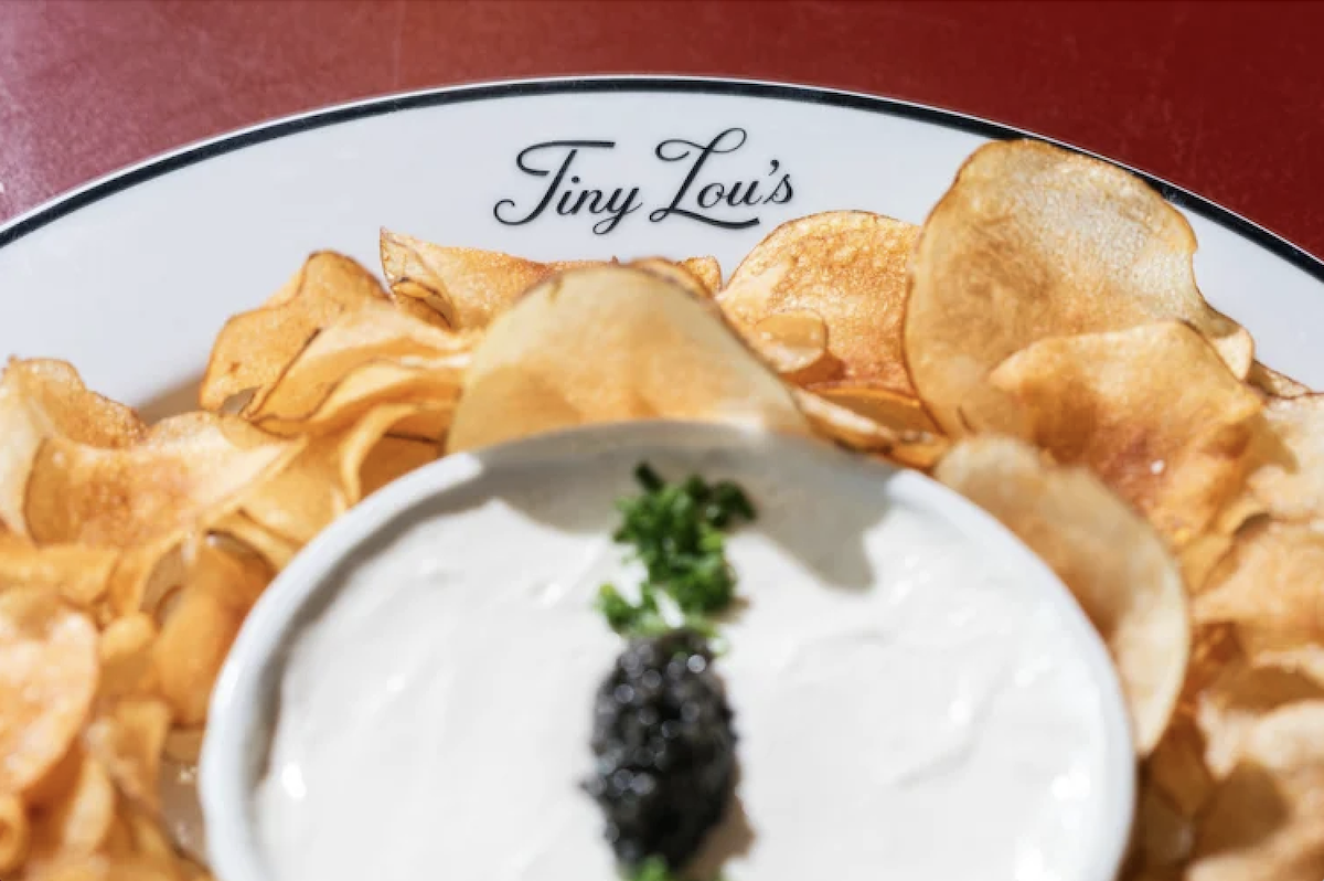 Housemade potato chips served with French onion crème, caviar, and chives at Tiny Lou's. | Photo by Tiny Lou's