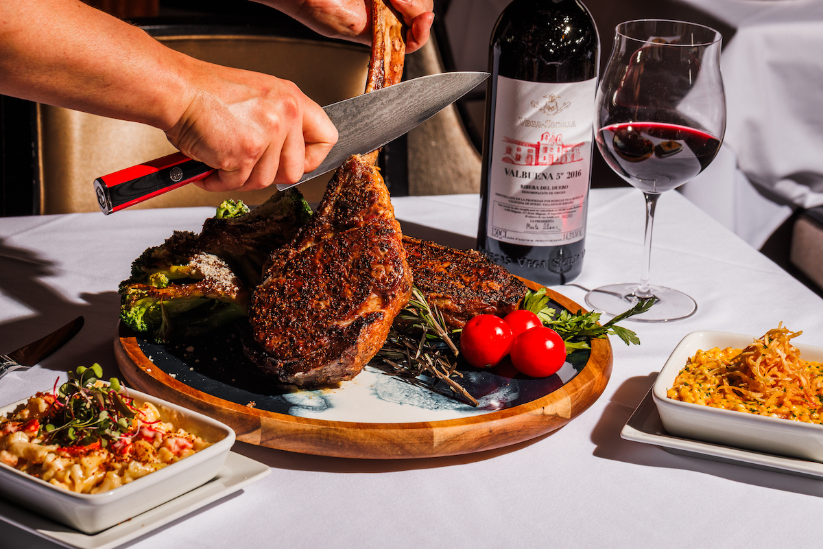 A seared tomahawk steak takes center stage at Dee Lincoln, carved tableside and paired with bold sides. | Photo by S. Reynolds