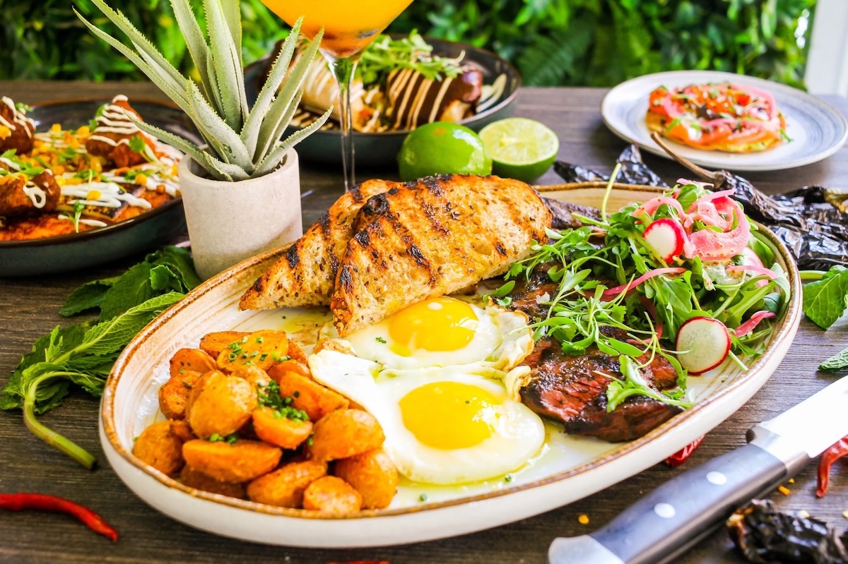 A brunch spread featuring sunny side up eggs, breakfast potatoes, toast, and more at Alta Toro. | Photo by Alta Toro