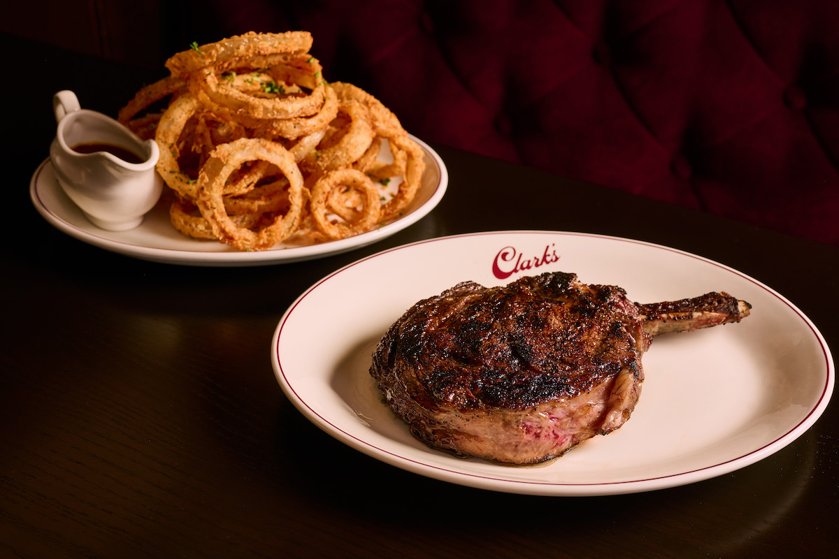 Steak with crispy onion rings served with a side of steak sauce at Clark's Steakhouse. | Photo by Angie Webb