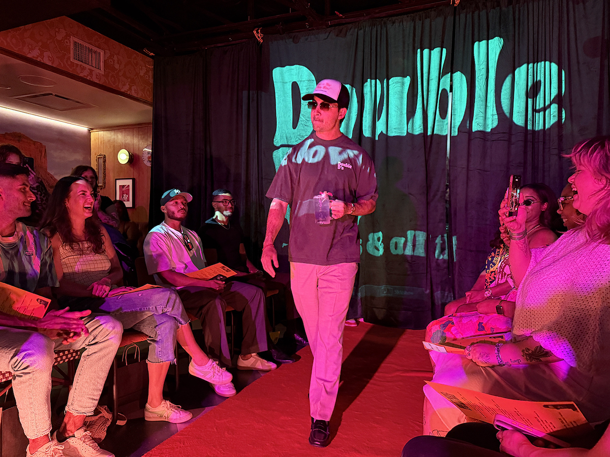 A model walks the runway with the Violet Breeze cocktail. | Photo by Desiree Gutierrez