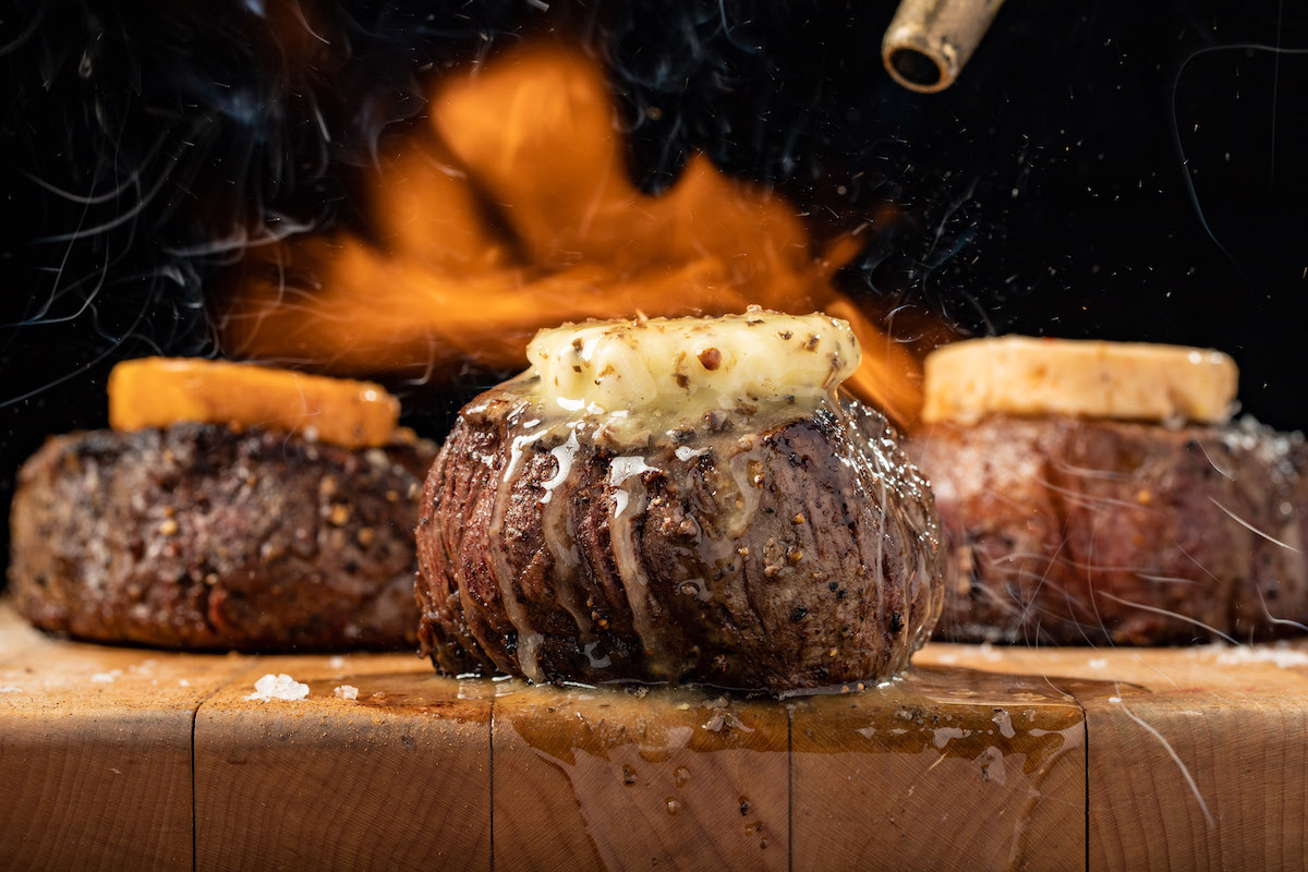 Sizzling perfection from STK—flame-kissed filet topped with melting butter, dripping with flavor in every bite. | Photo by the One Group