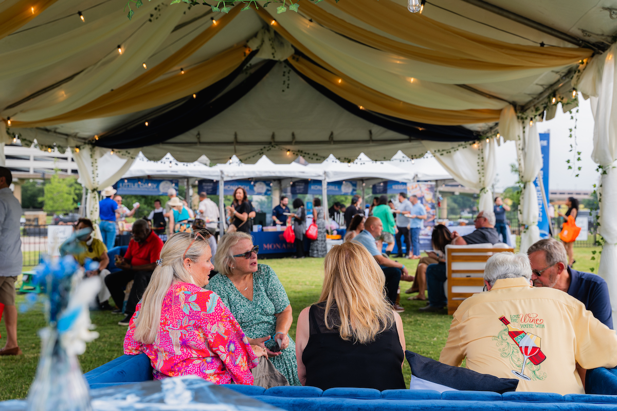Attendees relax in between bites of steak at the RARE Steak Championship at Levy Park. | Photo by Dacoge Media