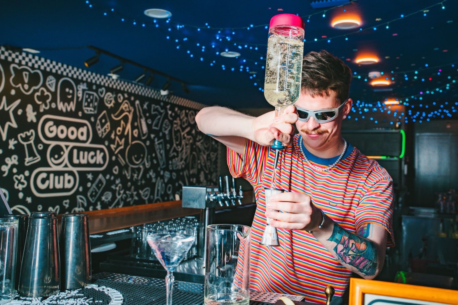 Bartenders pour signature drinks and rotating specials | Photo by Good Luck Club