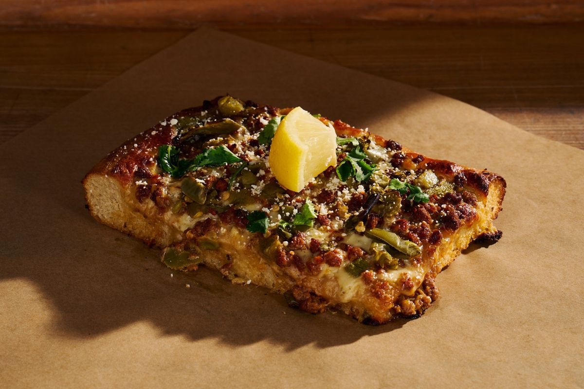 A slice of the Chorizo Verde pie | Photo by Barrio Bagel & Slice