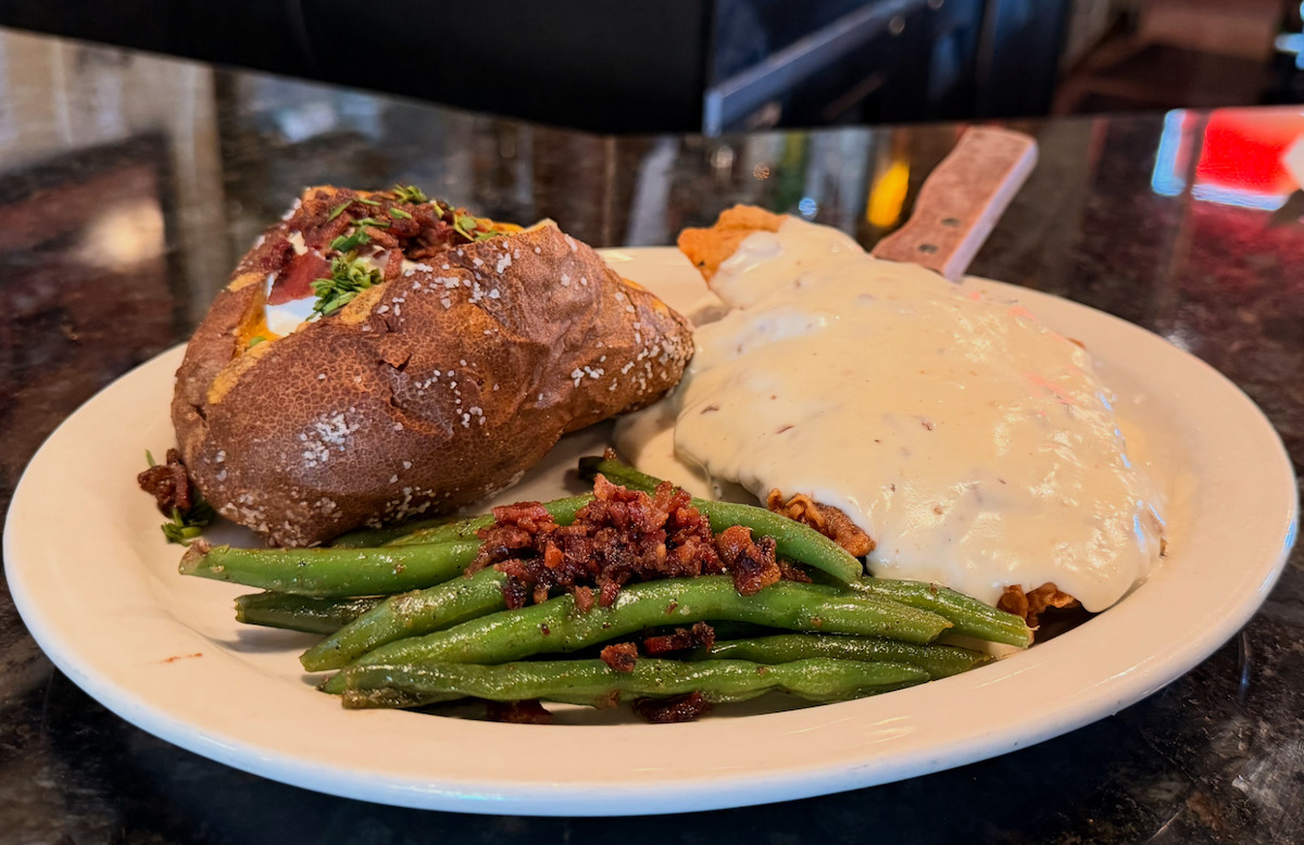 Chicken fried steak with green beans and a baked potato at Tolbert’s Restaurant & Chili Parlor. | Photo by Tolbert’s Restaurant & Chili Parlor