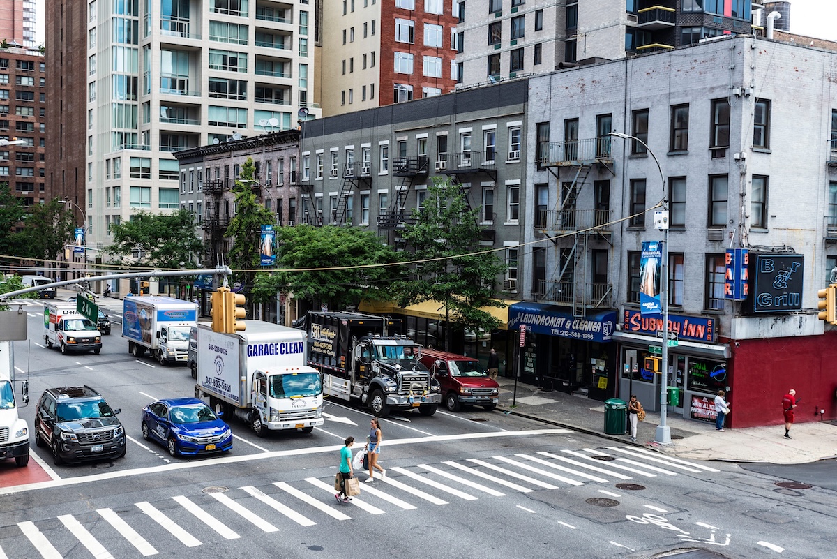 New York City, USA - July 31, 2018: Overview of a street with its skyscrapers, traffic and people around in Manhattan, New York City, USA