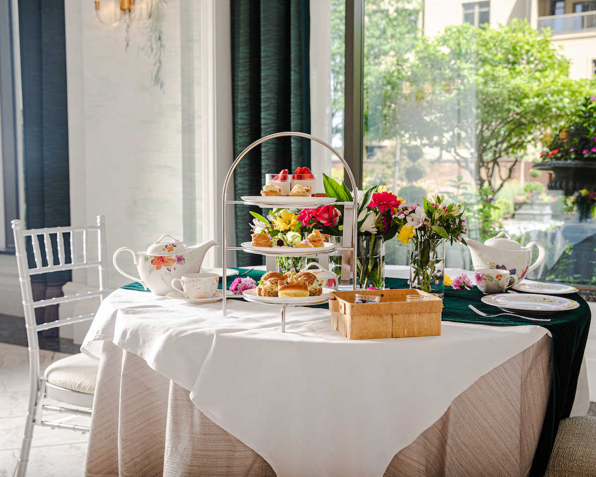 Afternoon tea at the Waldorf Astoria Atlanta pairs elegant tiered trays of pastries, tea sandwiches, and sweets with garden views inside the hotel’s light-filled Belvedere Room. | Photo by Waldorf Astoria Atlanta