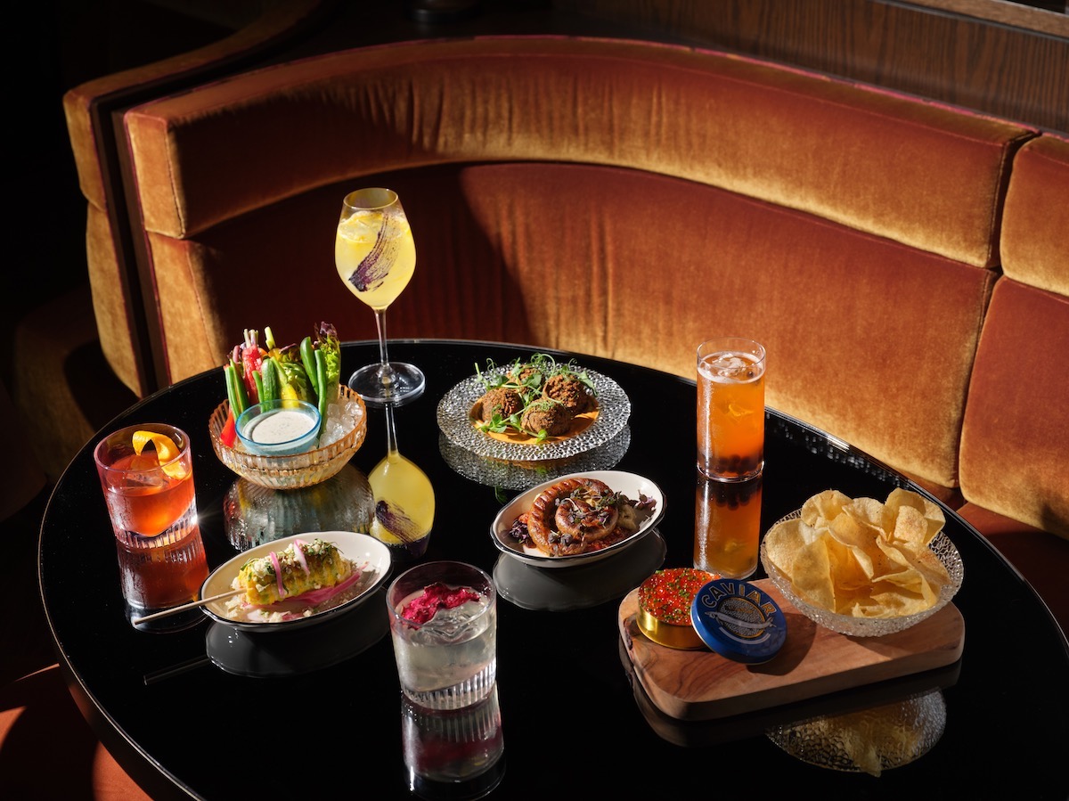 A colorful spread of food and cocktails offered at Bar Daphne. | Photo by Robert Gomez