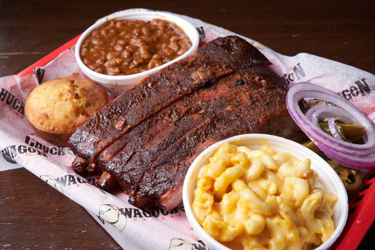 Chuck Wagon - DiningOut Smoked barbecue ribs with mac and cheese, baked beans, jalapeños, and red onion slices at Chuck Wagon BBQ. | Photo by Chuck Wagon BBQ