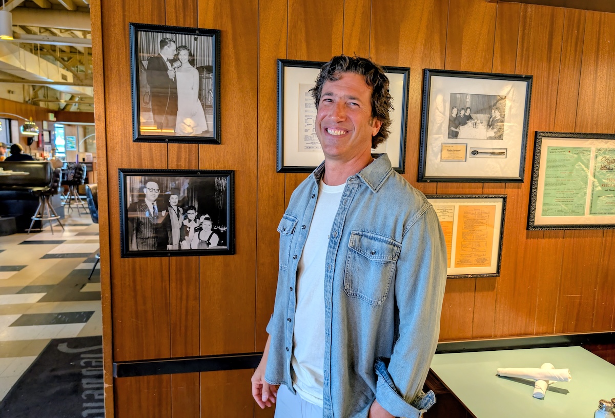 Josh Wolkon today, overseeing the wall of memorabilia. | Photo by Linnea Covington