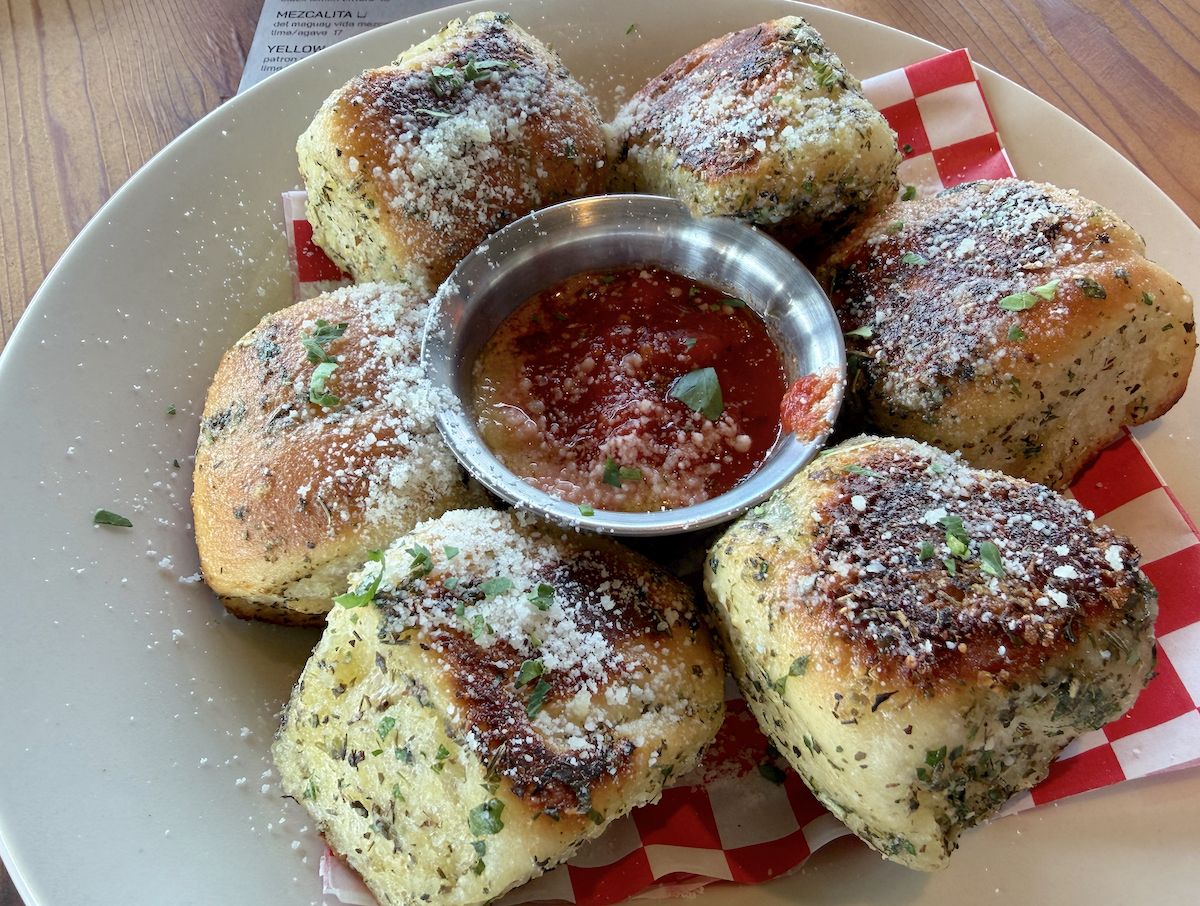 Kilmac’s garlic knots are baked twice and coated in house-made “schmutz” made with olive oil, confit garlic, herbs, and Parmesan. | Photo by Desiree Gutierrez