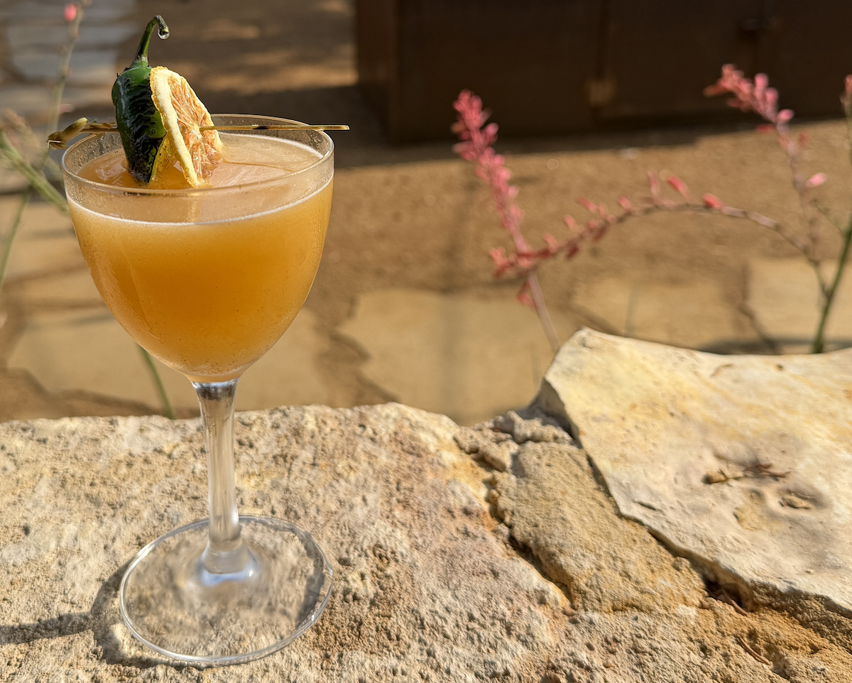 The Santa Muerte cocktail combines mezcal de pechuga, peach, Amaro Montenegro, lemon, and serrano hot honey for a smoky-spicy finish. | Photo by Desiree Gutierrez