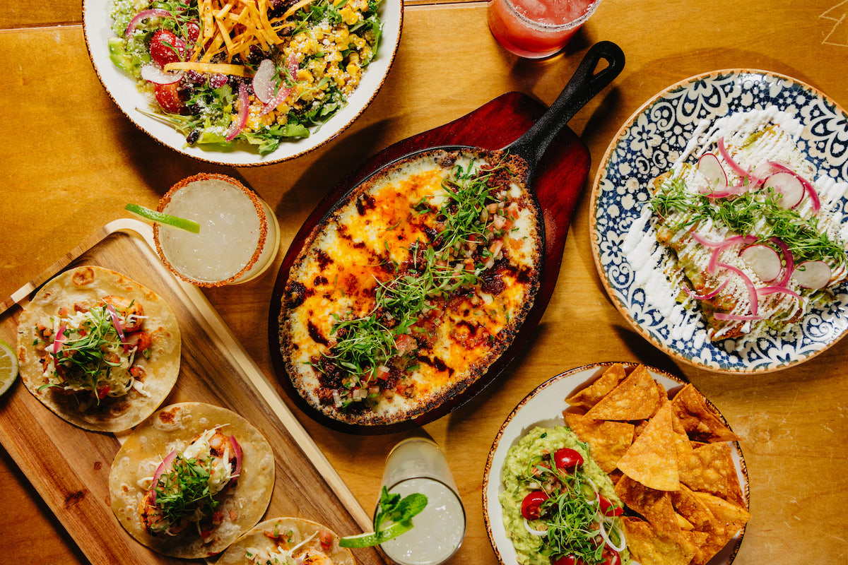 A colorful spread of Luna Roja favorites, from tacos and enchiladas to fresh margaritas and vibrant salads. | Photo by Luna Roja