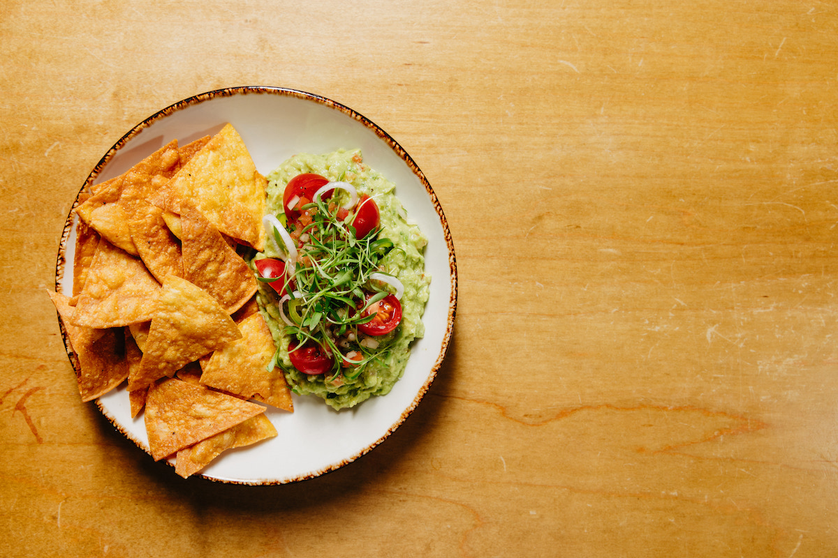 Fresh guacamole topped with pico de gallo, served with tortilla chips. | Photo by Luna Roja