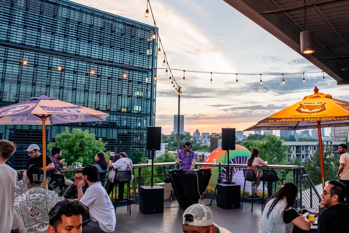 A DJ entertains guests on the sprawling rooftop patio at New Realm Brewing. | Photo by New Realm Brewing