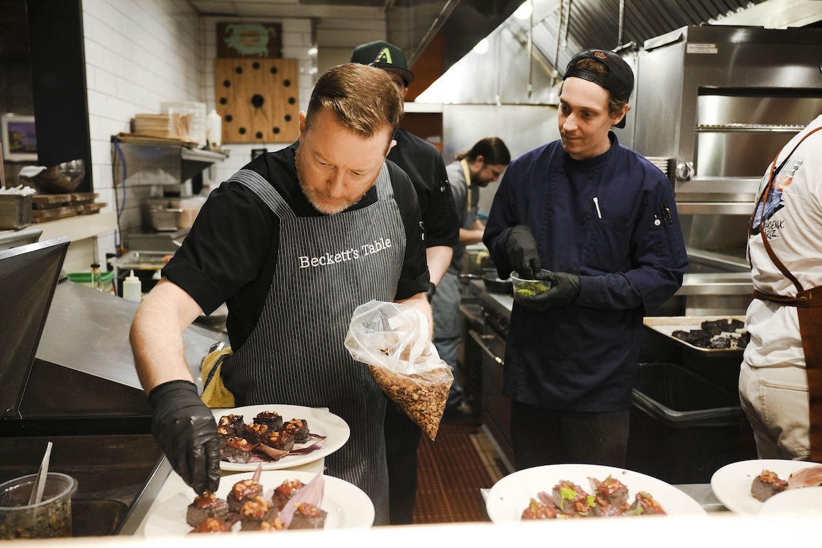 Chef Justin Beckett cooking at one of the 2025 dinners. | Photo courtesy of Devour Summer Chef Series