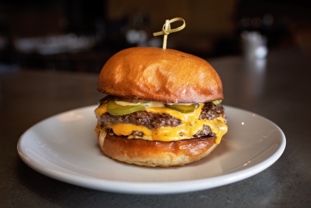 The Hush Burger features a two quarter-pound smash patties and locally sourced pickles. | Photo courtesy of Fire at Will 