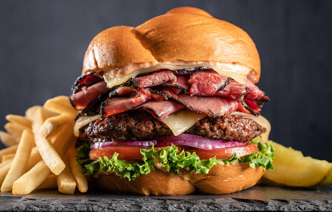 Get all the pastrami on top of a hamburger at this Phoenix favorite. | Photo courtesy of Miracle Mile Deli