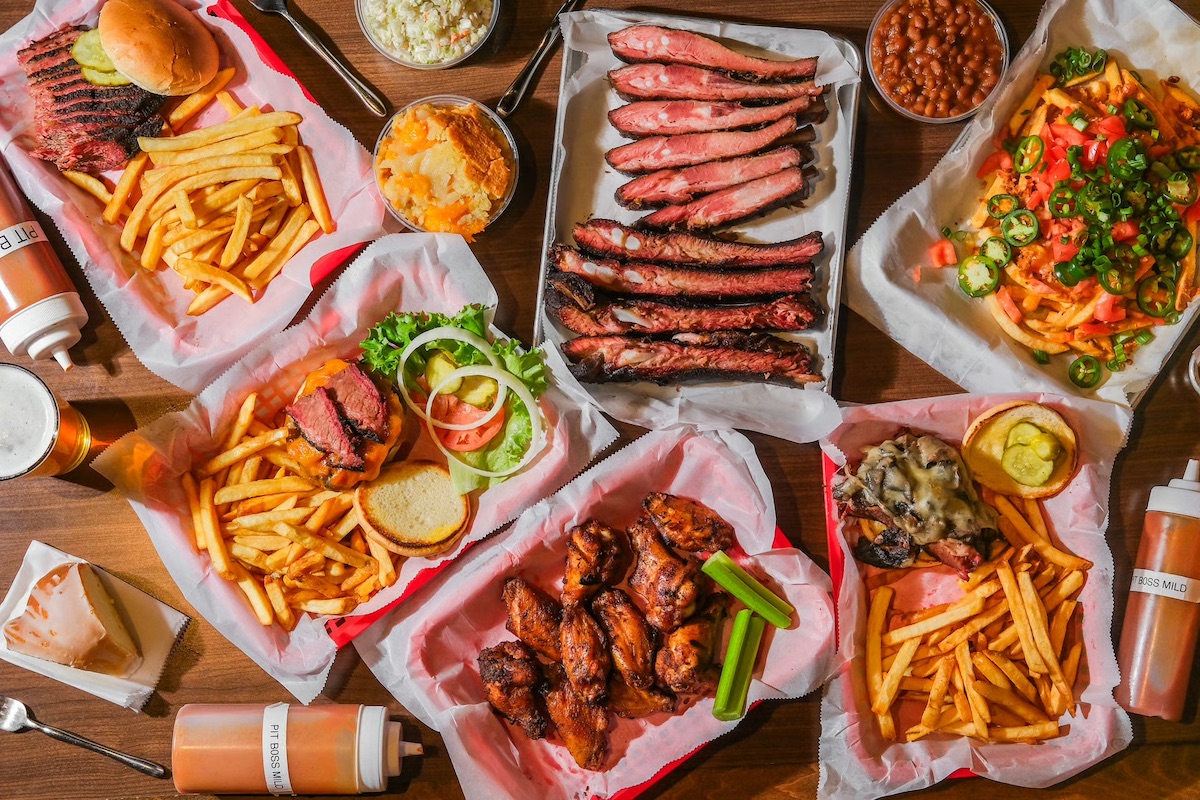 A full spread at Pit Boss BBQ in Hapeville features smoked ribs, brisket, wings, loaded fries, burgers, and classic Southern sides. | Photo by Pit Boss