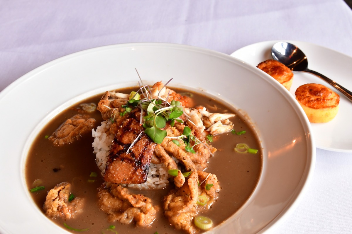Willie G’s takes soft shell crab to decadent territory with a fried crab-topped gumbo loaded with shrimp, oysters, and rich dark roux flavor. | Photo by Willie G's