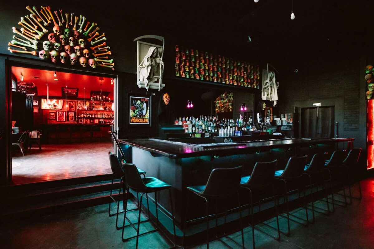 the crypt - DiningOut Expect a long black bar, neon lights, and skull and crossbones decor | Photo courtesy of The Crypt