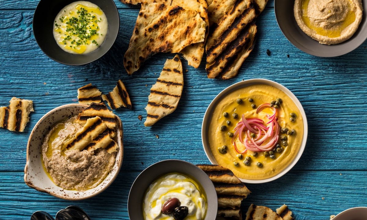Pita, hummus, and other various dips at Kyma. | Photo by Kyma