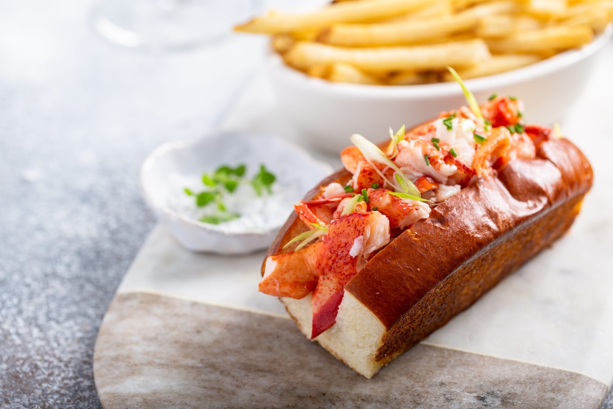 Lobster roll with fries on a marble board new york nyc