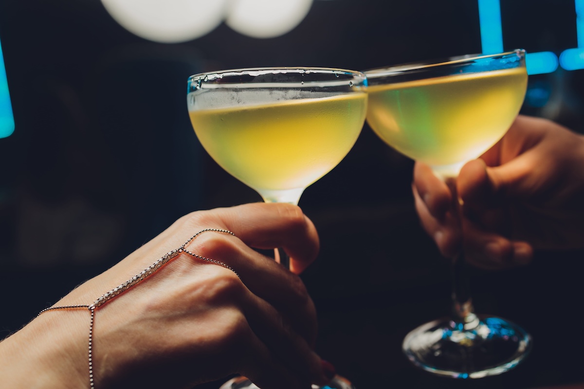 Close up shot of group of people clinking glasses with wine or champagne in front of bokeh background. older people hands. nyc denver phoenix