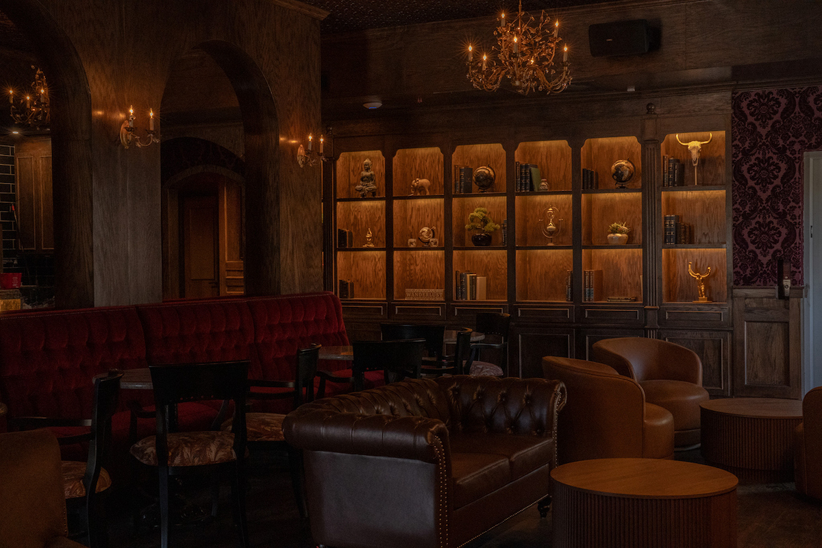 A hidden bookshelf conceals the entrance to Library Bar, Atlas Houston Heights' intimate upstairs speakeasy. | Photo by Joseph Rojas