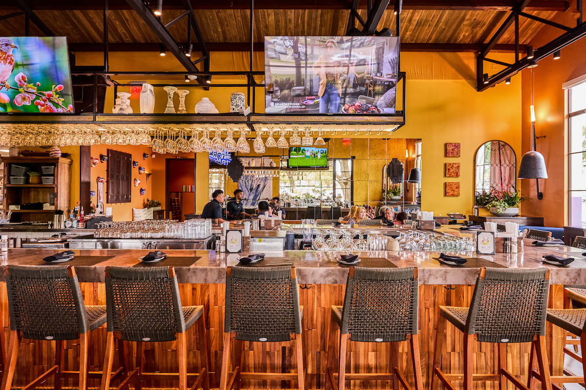 Escalante's - DiningOut The heart of Escalante’s: a warm, inviting bar framed by rustic wood accents, soaring ceilings, and plenty of room to gather over handcrafted cocktails, margaritas, and Mexican favorites. | Photo by Escalante's