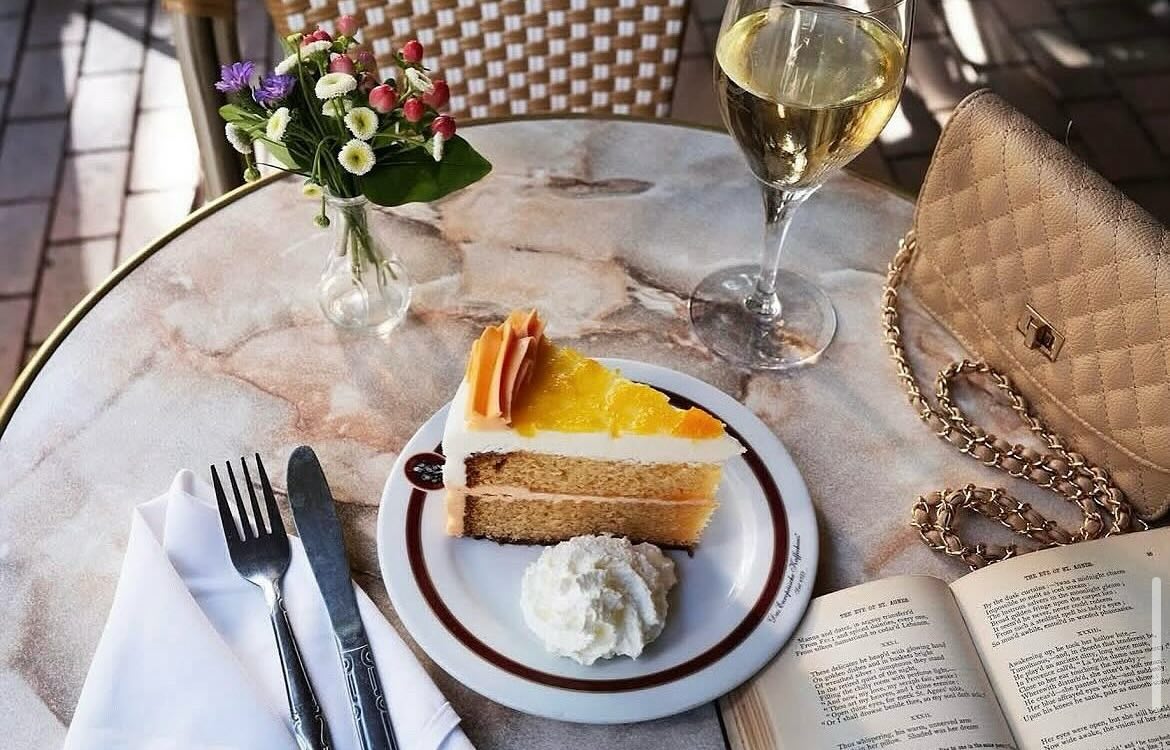 Cafe Intermezzo Peaches and Cream Torte - DiningOut Cafe Intermezzo’s peaches and cream torte is just one of dozens of cakes, tortes and pastries that fill the beloved café’s legendary dessert case. | Photo by Cafe Intermezzo