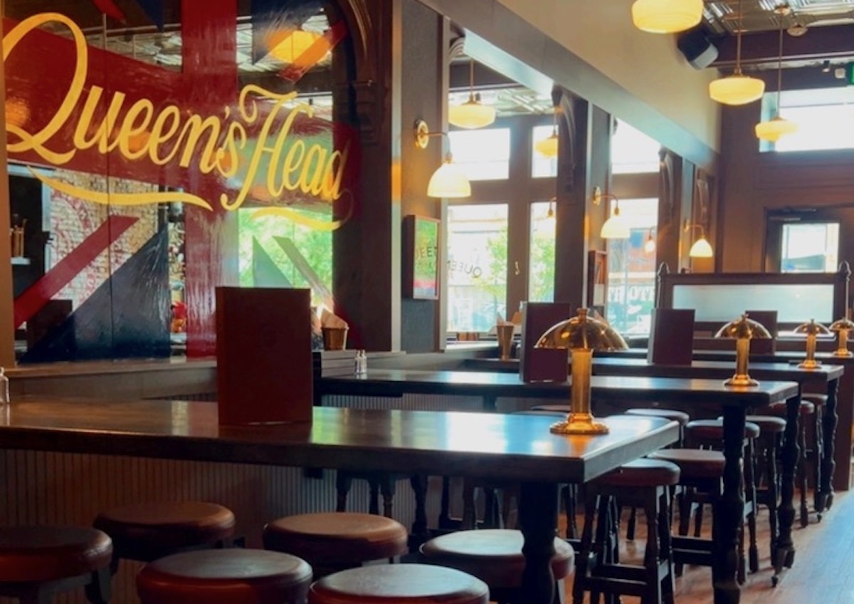 Dark woods, brass accents, and cozy seating give Queen’s Head Pub the feel of a traditional British public house in the heart of Deep Ellum. | Photo by Queen's Head Pub