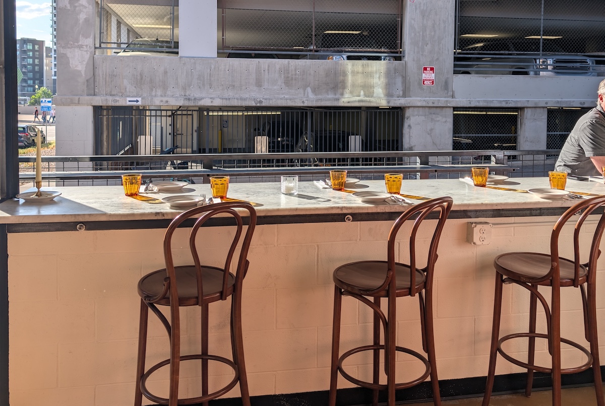 One wall of Heretik opens up to reveal double-sided high-top seating. | Photo by Linnea Covington