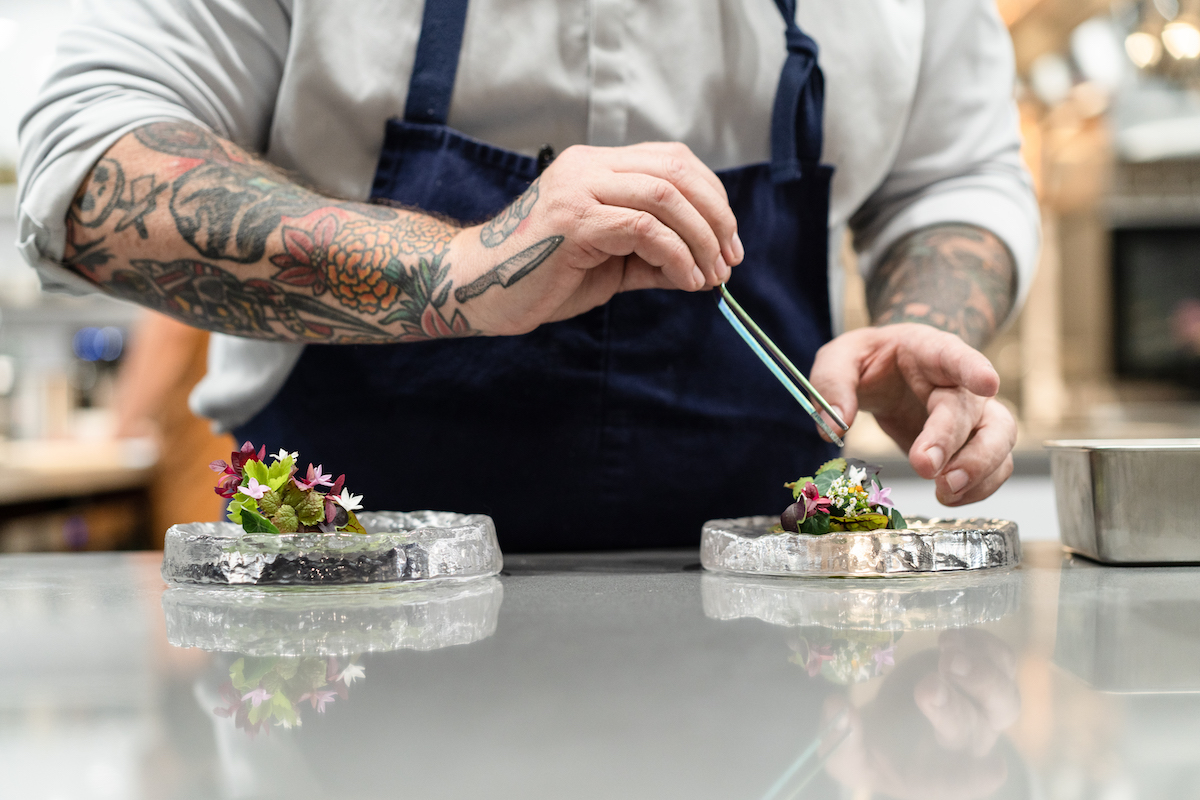 James Beard Award-winning chef RJ Cooper and his team put the finishing touches on one of Punk Noir's meticulously plated courses in the kitchen. | Photo by Amy Zawacki
