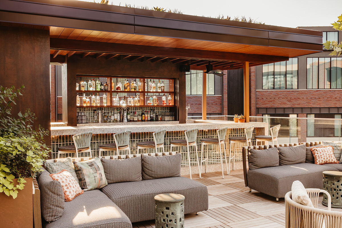 The Terrace Pool at Bowie House offers a stylish retreat complete with plush loungers, a sophisticated pool bar, and resort-style amenities. | Photo by Bowie House Auberge Collection
