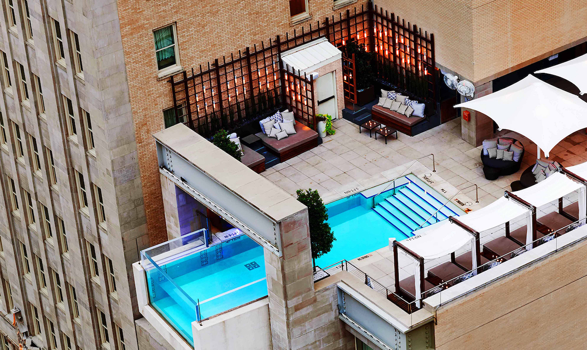 The Joule's iconic cantilevered pool extends eight feet beyond the hotel's facade, creating one of Dallas' most recognizable swimming experiences. | Photo by the Joule