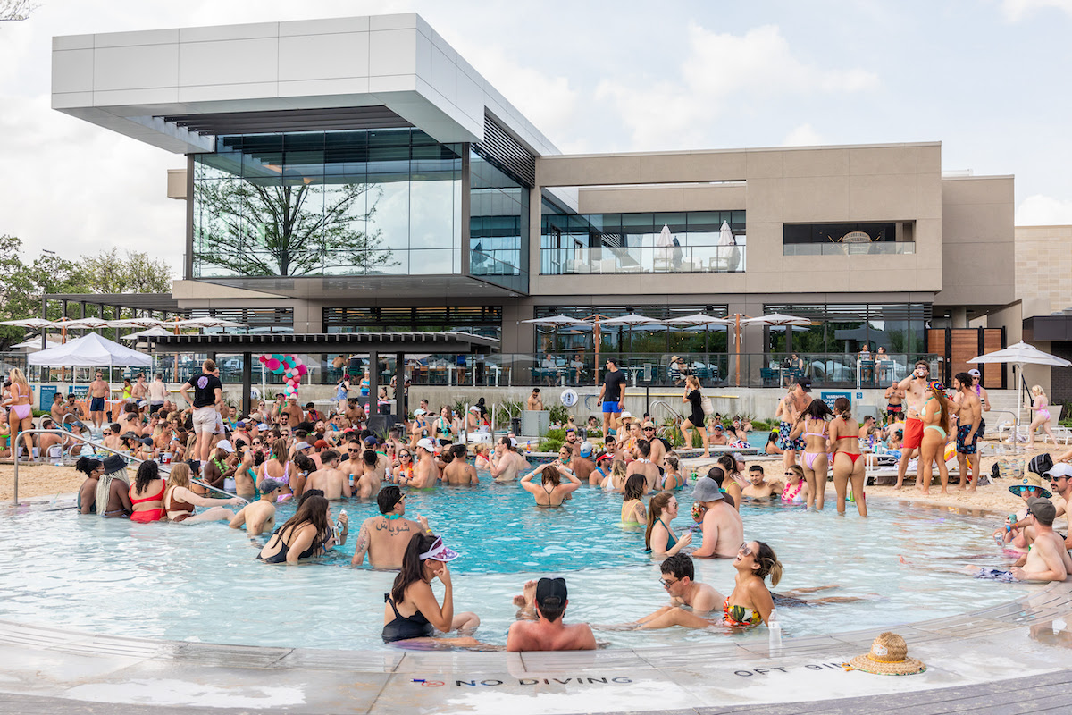 The Village Beach Club transforms summer into a social affair with sprawling pools, a swim-up bar, live events, and beach-inspired lounging. | Photo by the Village